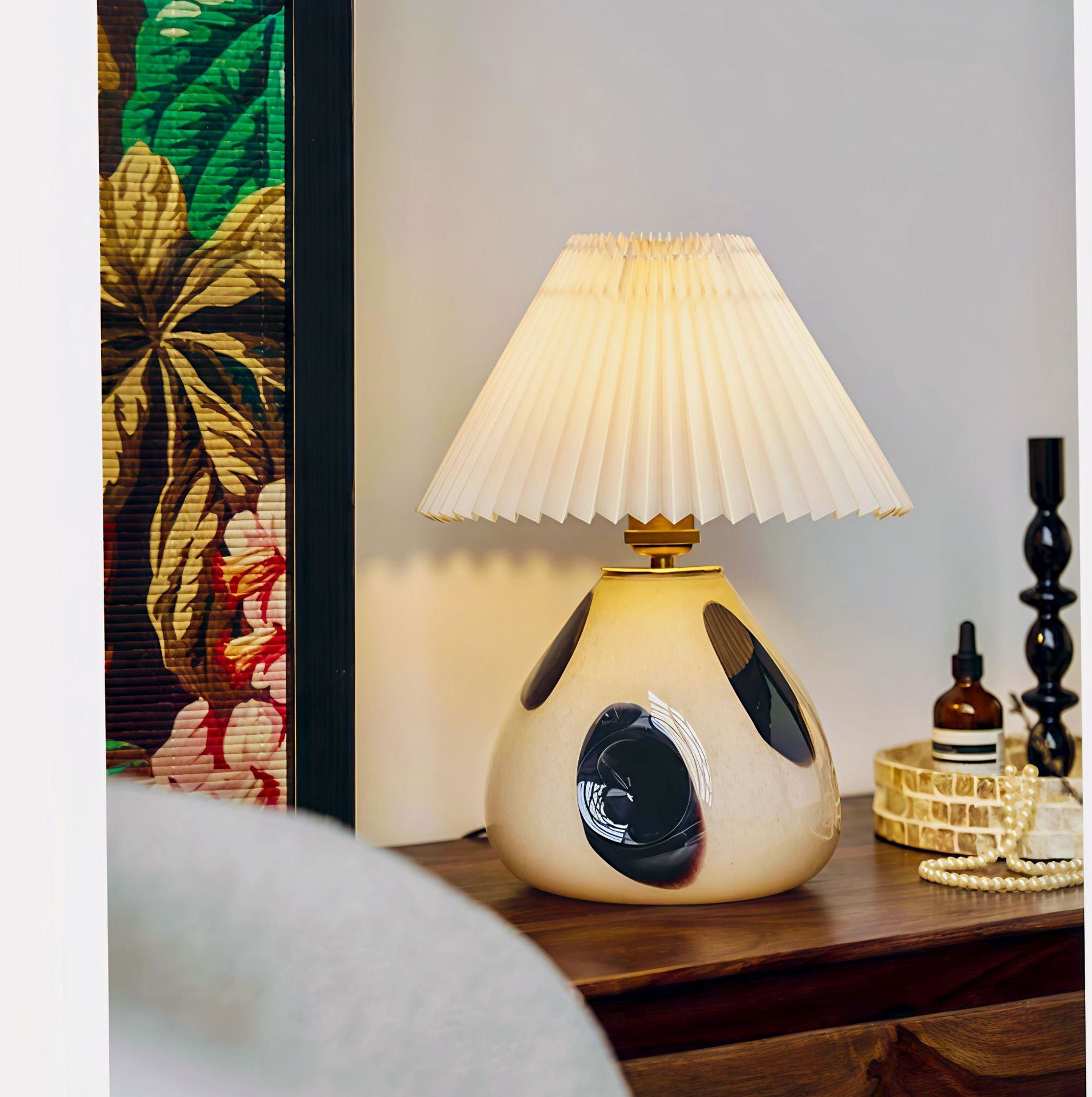 Side angle of spotted ceramic lamp on wooden console