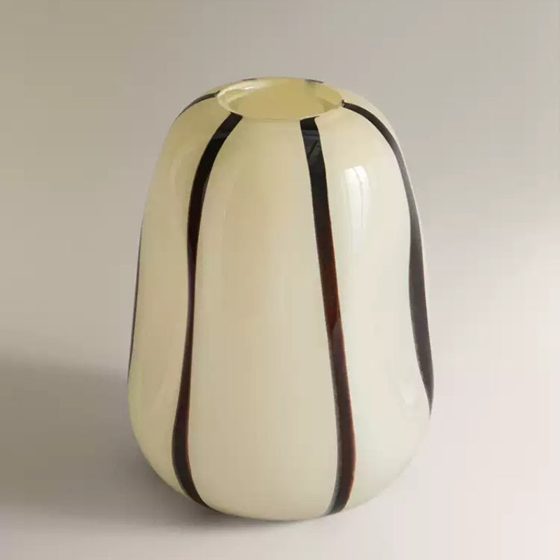 Front view of cream glass vase with vertical black stripes