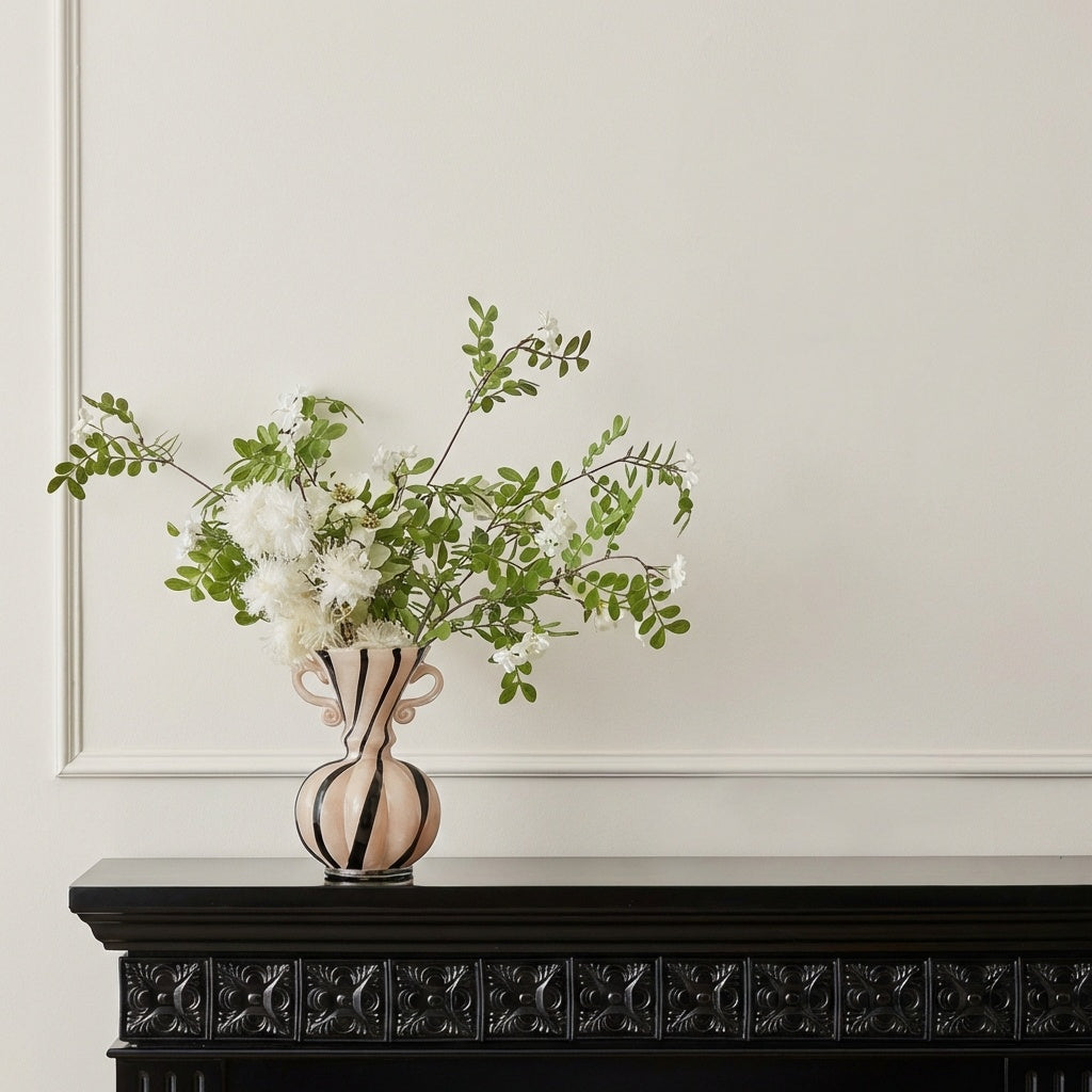Wide shot of striped vase on mantelpiece with decor
