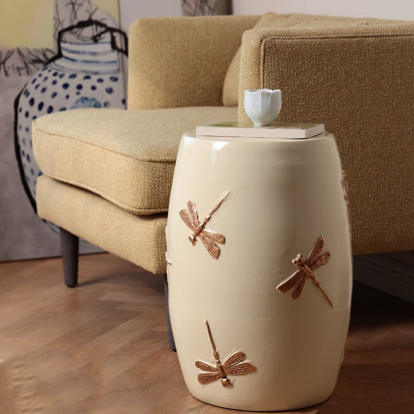 Cream ceramic drum stool with bronze dragonfly motifs side view