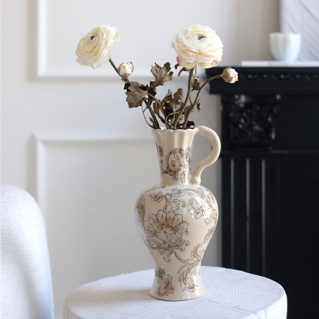 Cream floral ceramic pitcher vase with white flowers on table