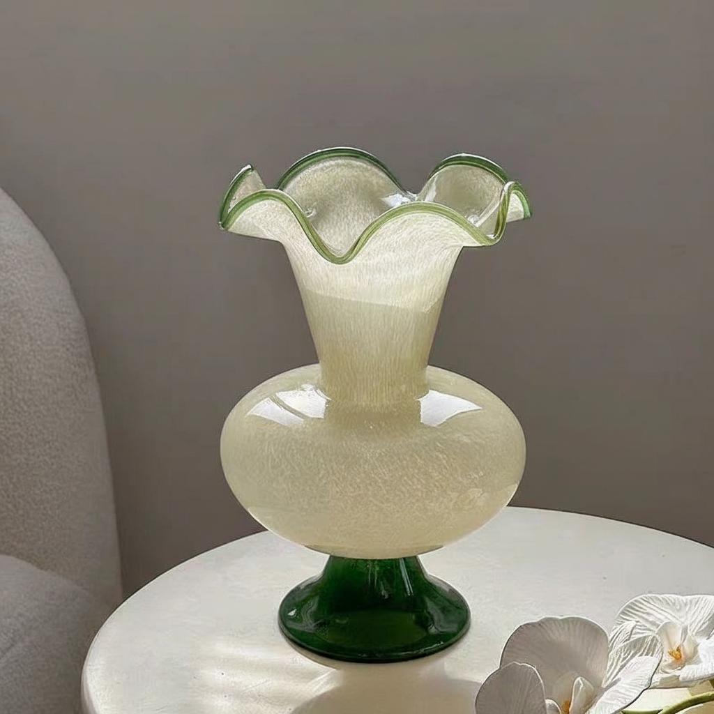 Close up detail of cream speckled glass body and green ruffled rim