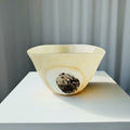 Front view of cream mottled art glass bowl with dark accent