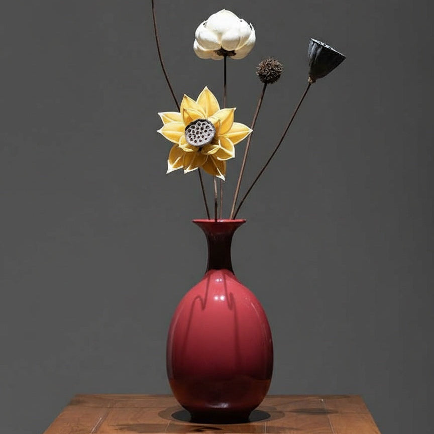 Crimson ceramic vase styled with dried floral arrangement