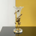 Full view of crystal vase with gold vine details on split background