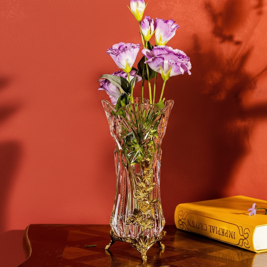 Crystal vase with brass floral vine accents on red background