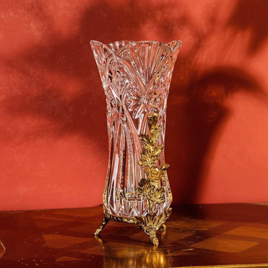 Crystal and brass vase displayed on a wooden surface