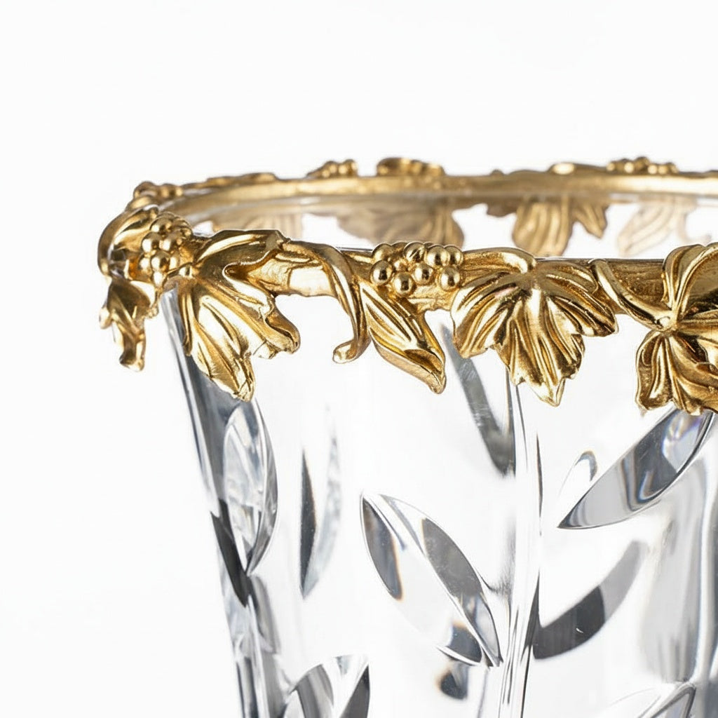 Close up detail of gold-finish brass grapevine rim on crystal vase
