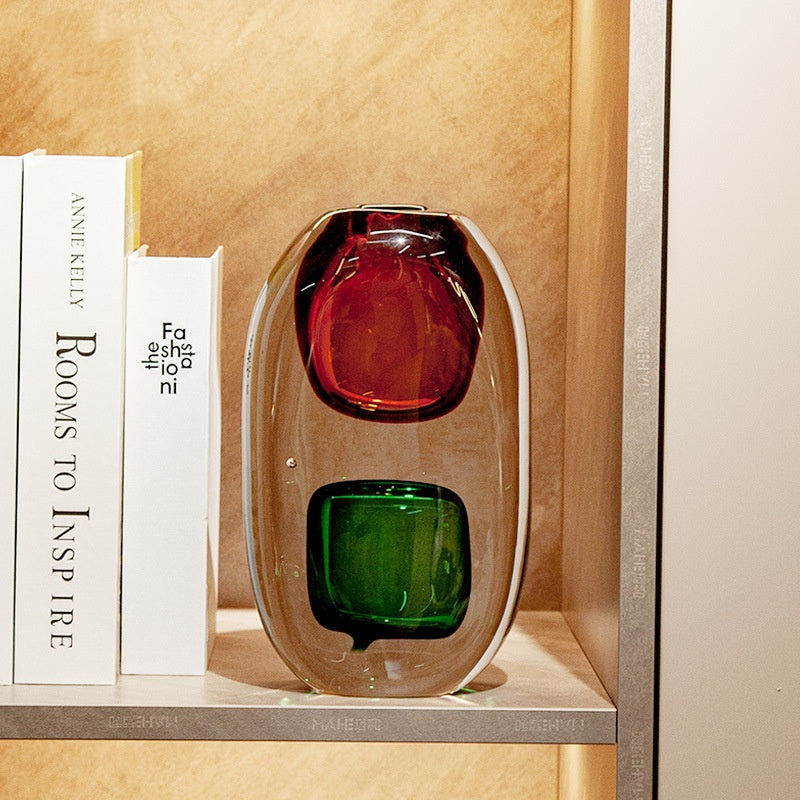 Two chamber crystal vase styled on a bookshelf with books