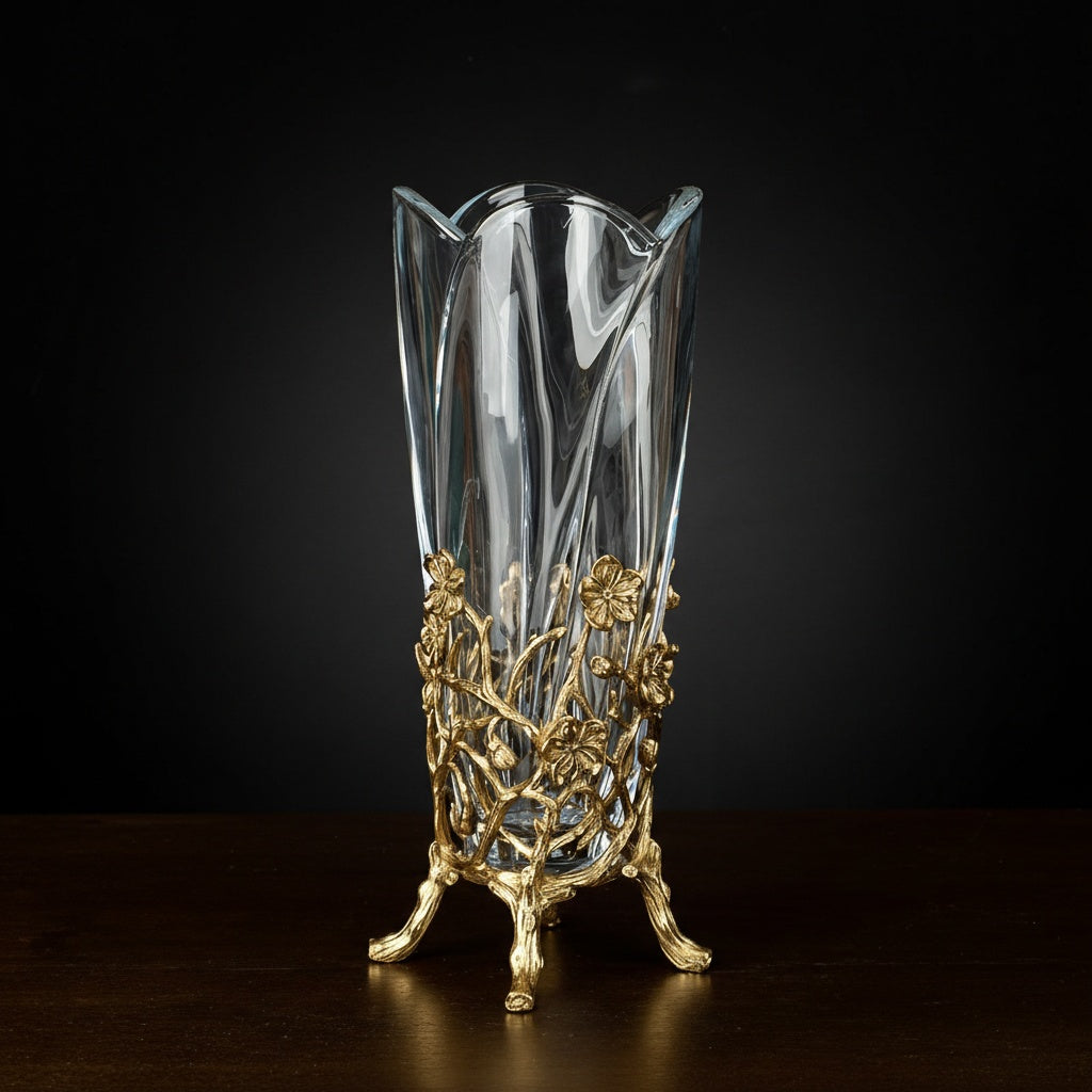 Full view of crystal glass vase with gold branch base on dark background