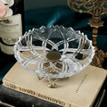 Crystal glass fruit bowl with brass pedestal stand on books