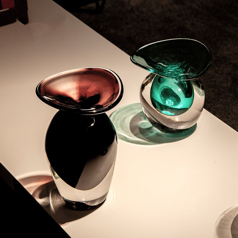 Purple and teal crystal glass vases styled together on table