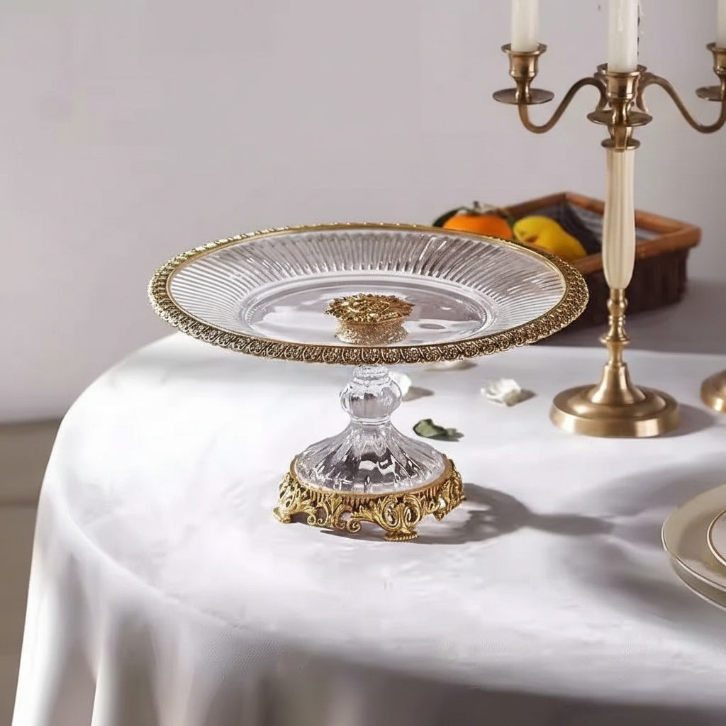 Empty crystal glass fruit bowl with ornate gold rim and base