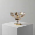 Detailed view of gold and crystal cut patterns on footed bowl