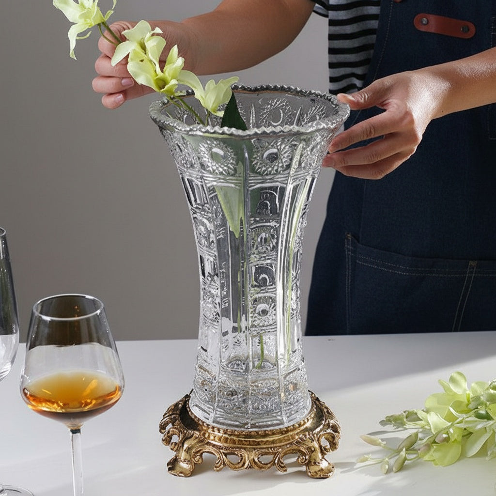 Full view of cut glass vase on gold base with flowers