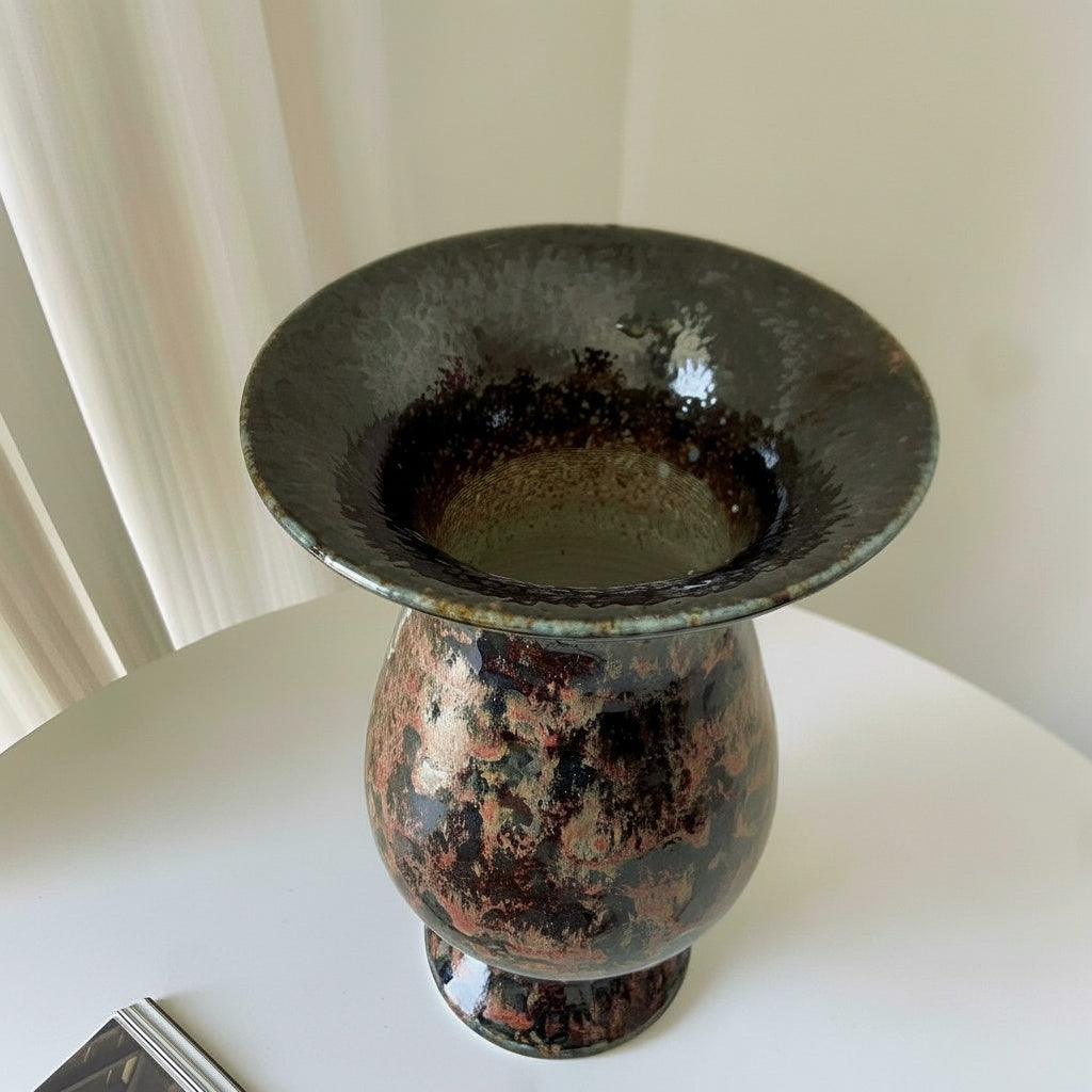 Dark copper glazed ceramic pedestal vase viewed from above