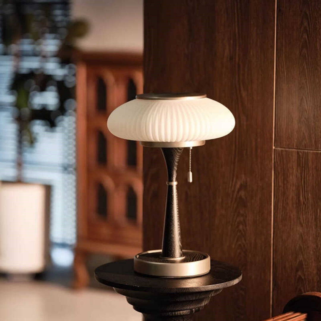 Dark wood and brass mushroom table lamp on side table