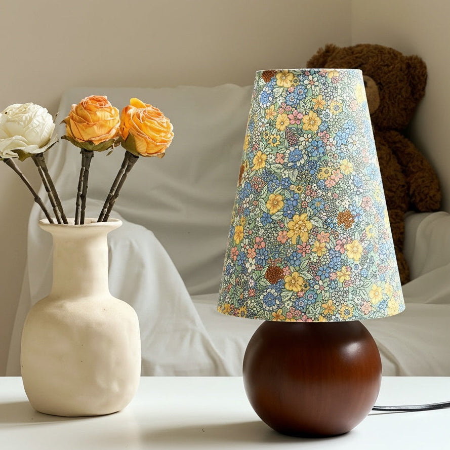 Illuminated floral shade table lamp in cozy bedroom setting