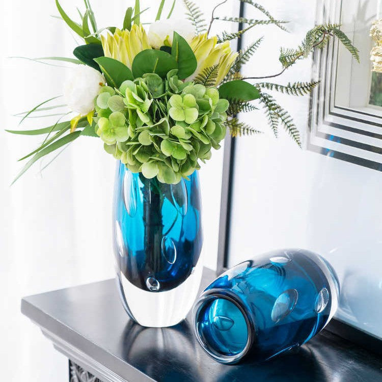 Set of two blue bubble glass vases styled in a luxury living room