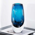 Solo shot of blue glass vase highlighting clear heavy base