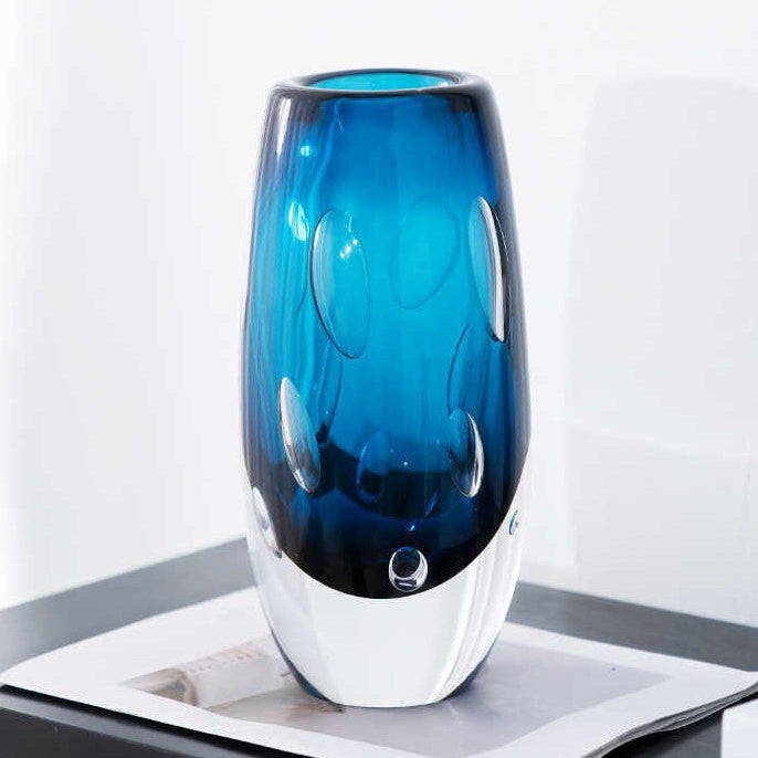 Solo shot of blue glass vase highlighting clear heavy base
