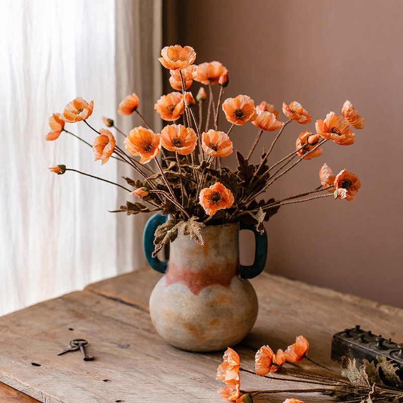 Rustic dual handle ceramic vase with orange poppies