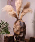 Brown textured ceramic vase with pampas grass