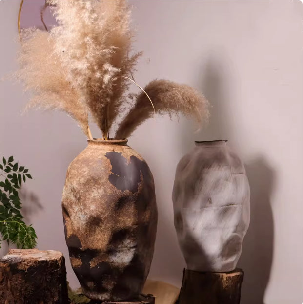 Pair of distressed ceramic vases in brown and white