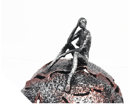 Close up detail of the contemplative figure and textured metal surface