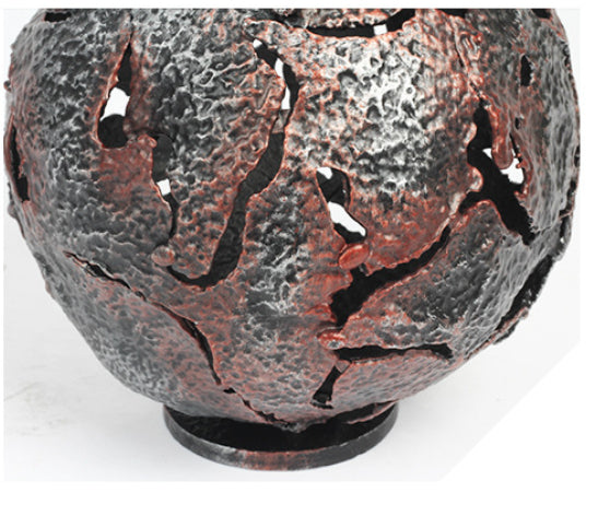 Detailed view of the hammered metal texture and cutouts on the sphere