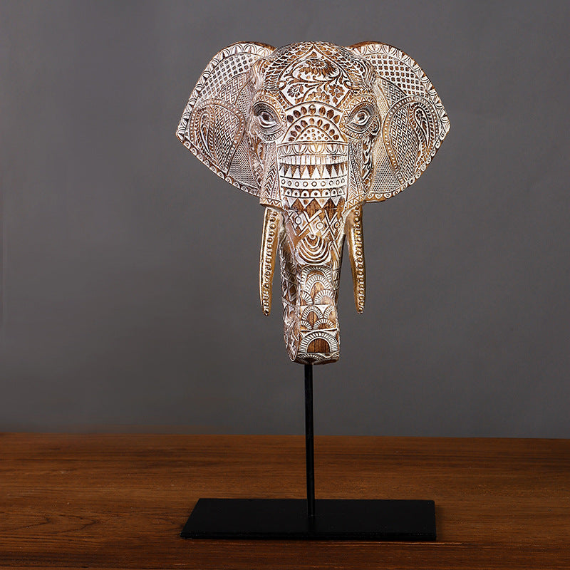 Front view of medium carved elephant head on stand