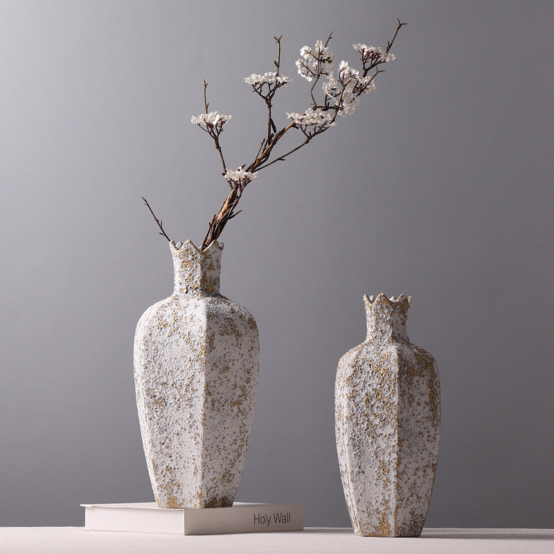 Two faceted ceramic vases with gold accents styled with branch