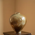 Front view of earth toned glazed ceramic vase with bulbous shape