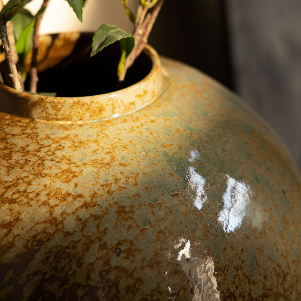 Close up of speckled glaze texture on earth toned ceramic vase