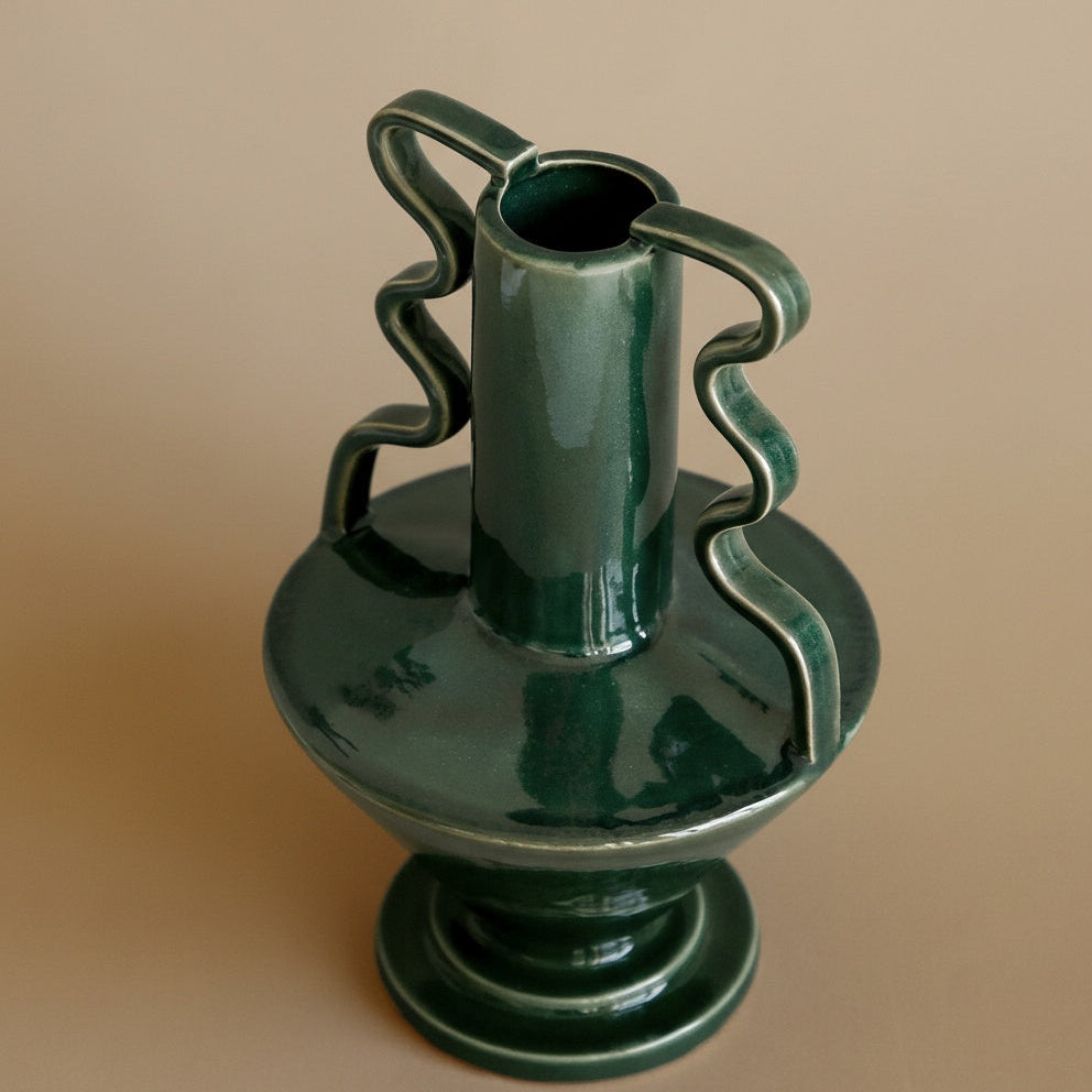 High angle view of sculptural green vase showing rim and shape