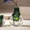 Detail of emerald green encased glass vase with organic shape