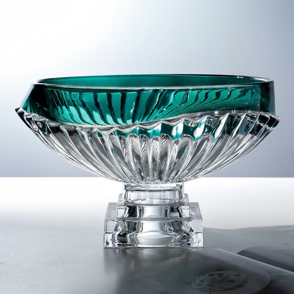 Side view of emerald green rimmed glass bowl on square pedestal base