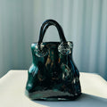 Front view of emerald green glass handbag vase