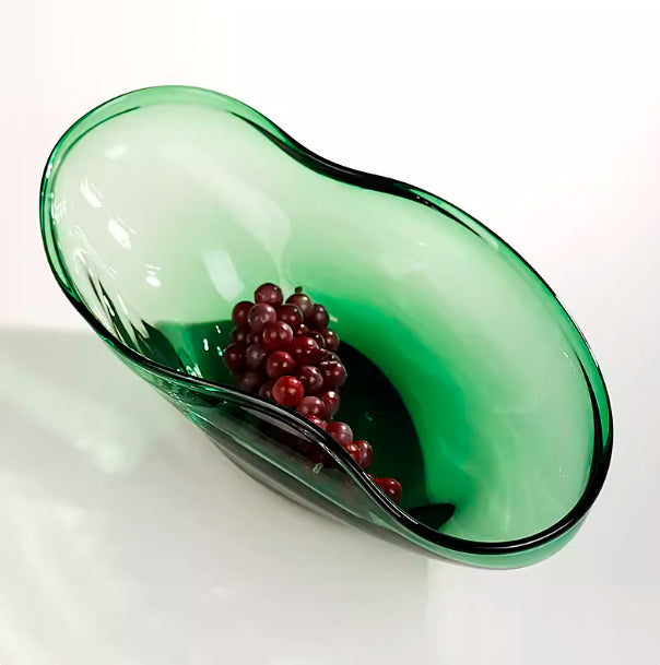 High angle view of organic green glass bowl showcasing curved rim