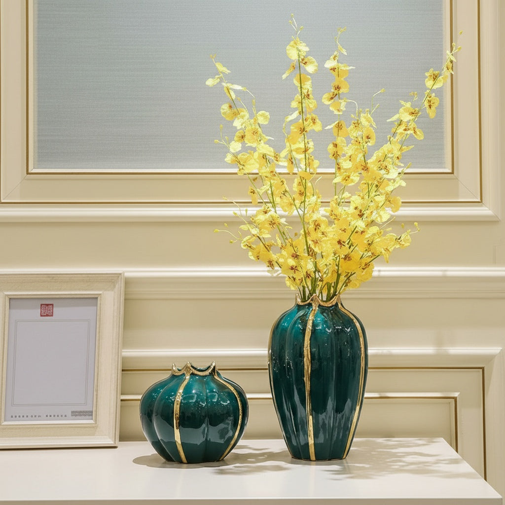 Emerald green ceramic vase set with gold ribbed detailing and yellow flowers