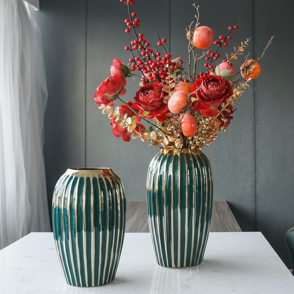 Two emerald green and gold striped vases displayed together