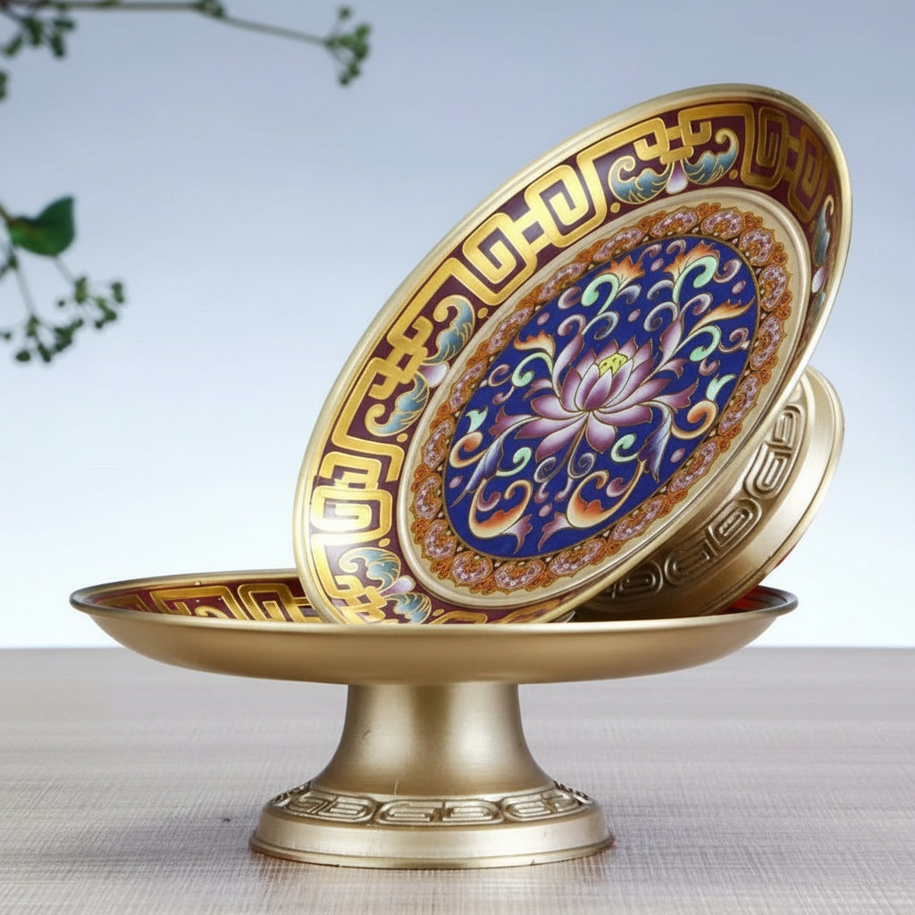 Side view of gold-tone pedestal dish with blue and red enamel details