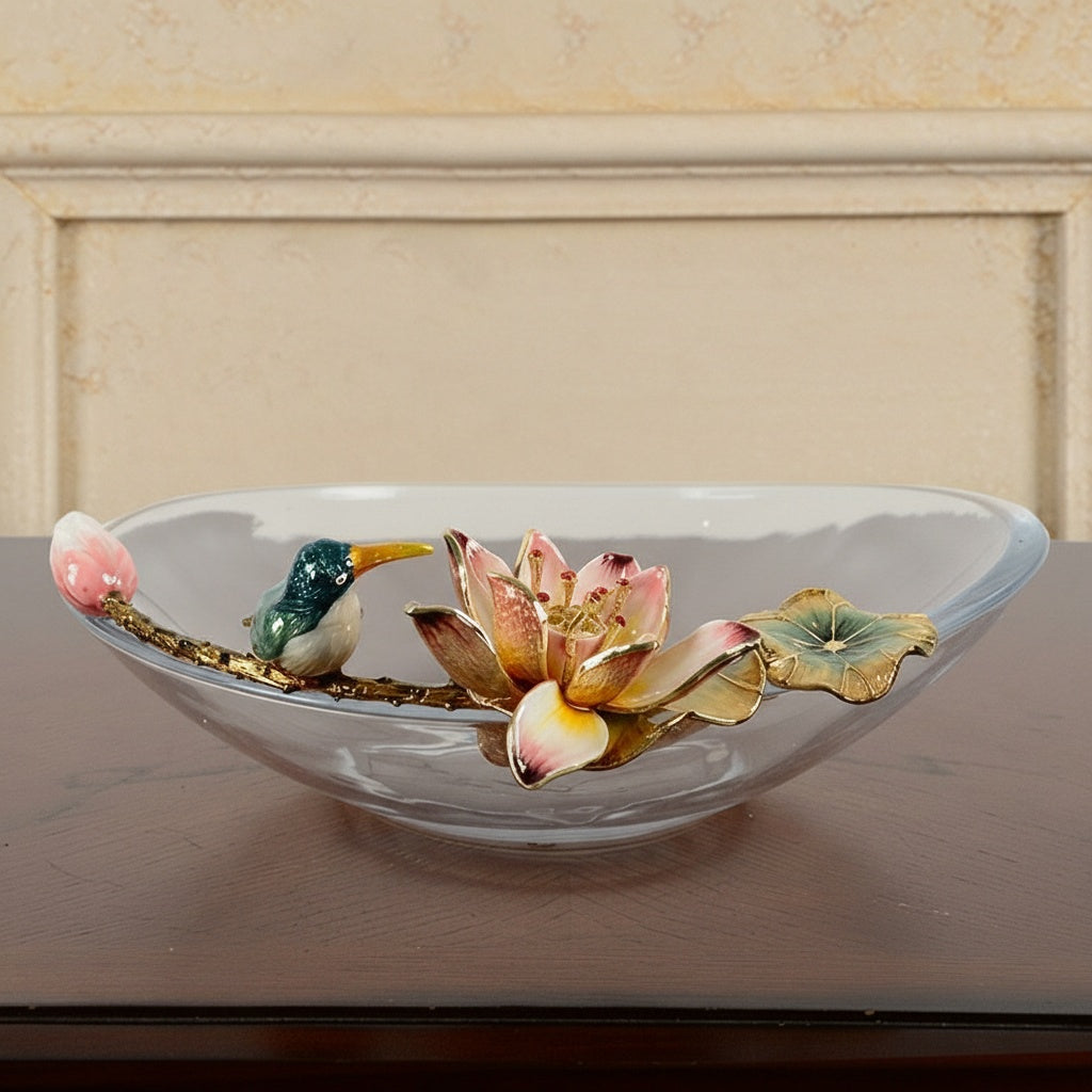 Detail view of kingfisher bird and pink lotus flower on glass bowl