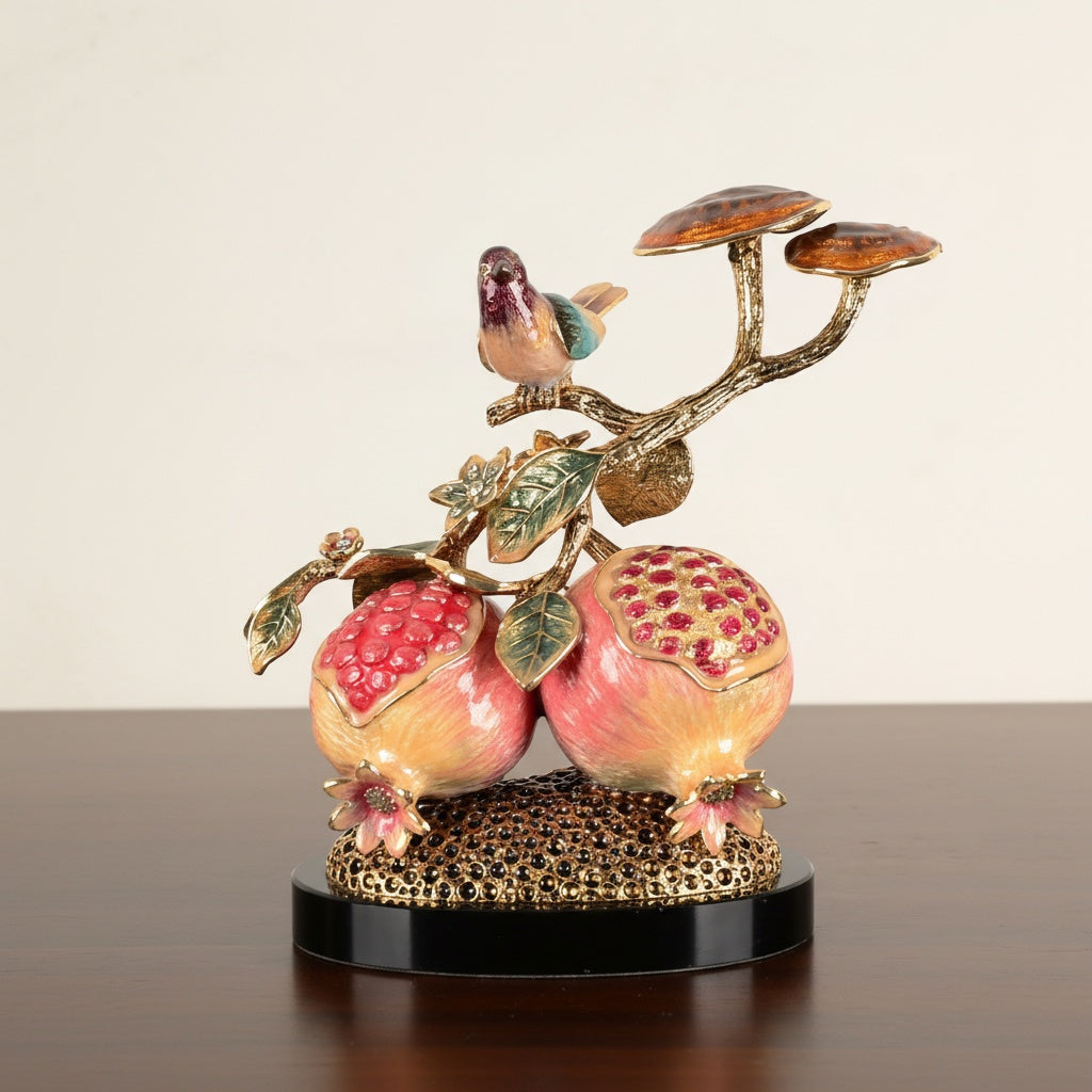 Front view of enameled pomegranate and bird sculpture on gold base