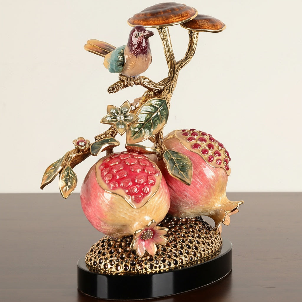Side angle of jeweled pomegranate sculpture with bird and mushroom details
