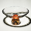 Faceted crystal footed bowl with amber center accent and geometric cuts