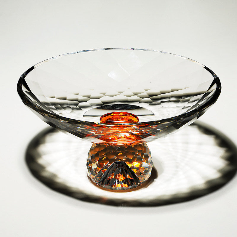 Faceted crystal footed bowl with amber center accent and geometric cuts