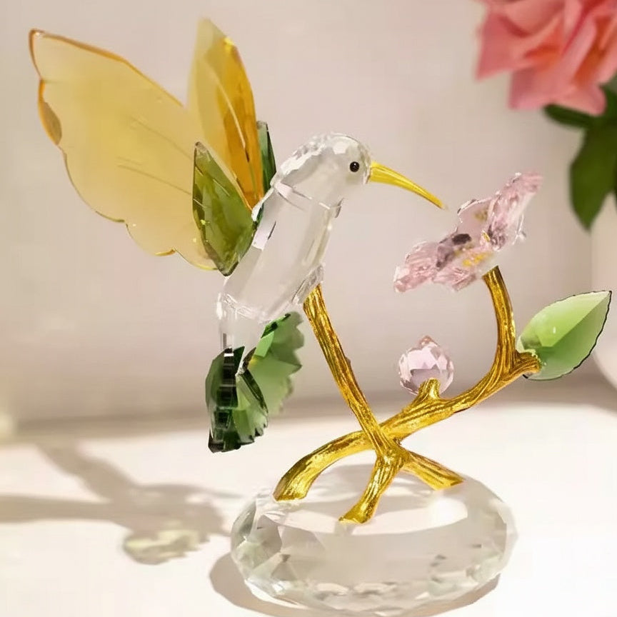 Side view of crystal hummingbird sculpture on gold tone stem