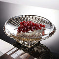 Amber faceted glass pedestal fruit bowl with grapes