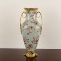 Floral ceramic vase with brass finish handles and base front view